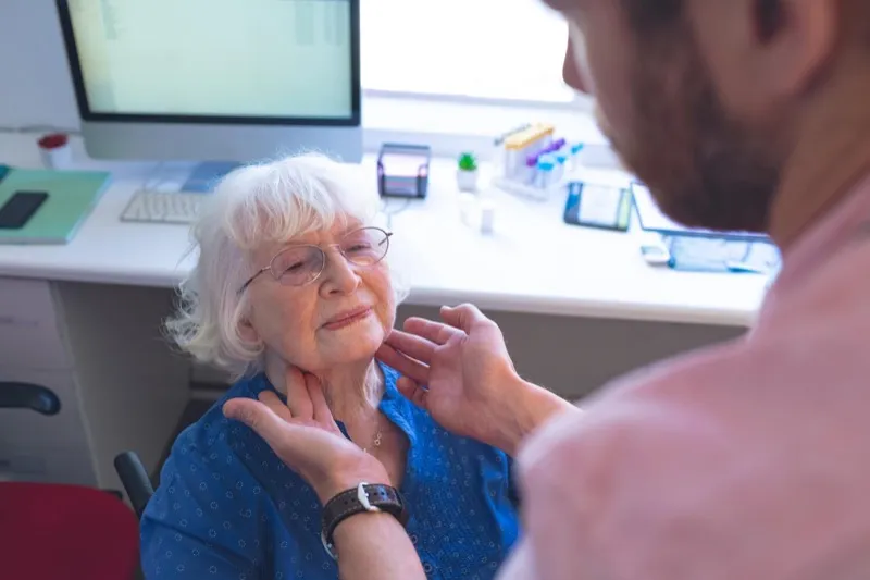 Doctor providing attentive clinical care to a senior patient during evaluation